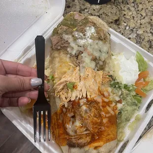 The Super Burrito (three meat burrito) with a fork for size reference
