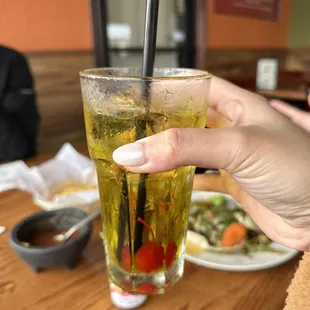 a person holding a drink with a straw