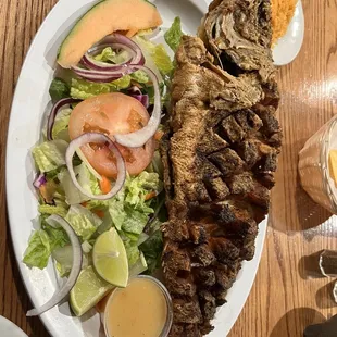 a plate of grilled fish and salad