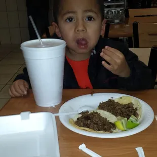My monkey with horchata his favorite drink and carne asada tacos he loves