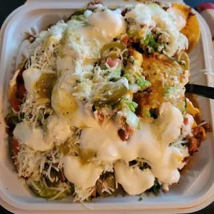 Large Nachos, buried with Sour Cream and shredded cheese (with Chorizo).