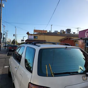 Yellow bldg is the restaurant. Vehicle parked illegally ,probably because they couldn't find parking.