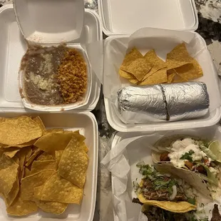 Three tacos, burrito, chips and  rice &amp; beans