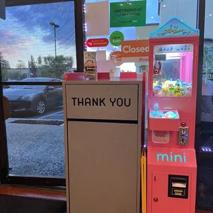 a pink vending machine with a thank you sign