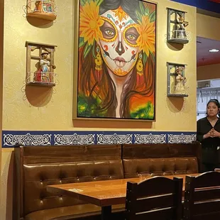 a woman with sugar skull makeup in a mexican restaurant