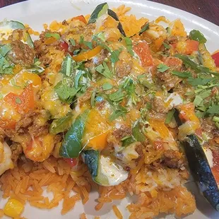 Calabasas Tiernas - Zucchini stuffed w Shrimp, Chorizo, Green &amp; Red Peppers and Roasted Corn topped w cheese creamy Chipotle sauce over rice