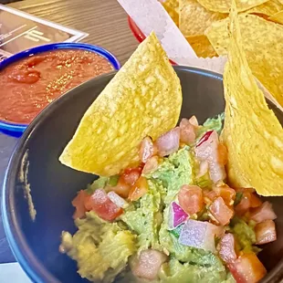 a bowl of guacamole and chips