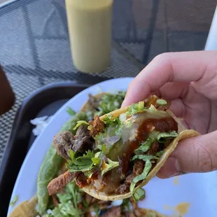 Carne Asada Street Taco with their red chipotle and green jalapeño sauce