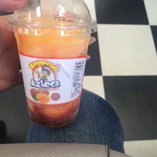 a person holding a cup of juice