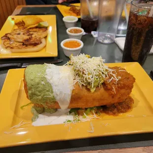 Chimichanga Lunch Special - Fried burrito, meat, salvadorian rice, black bean salsa, guac, chipotle cream, red sauce.