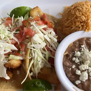 Fish and shrimp tacos with rice and beans