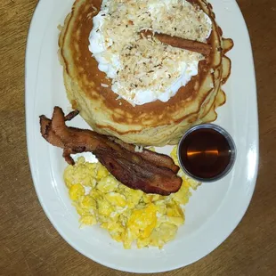 Coconut pancakes - toasted coconut, whipped cream, eggs bacon