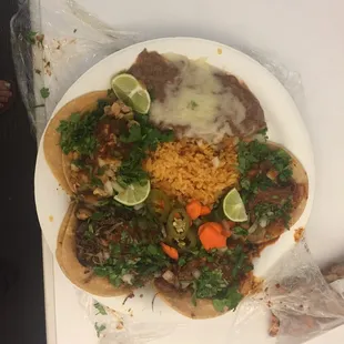 Tacos with a side of beans and rice