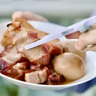 a person holding a plate of food