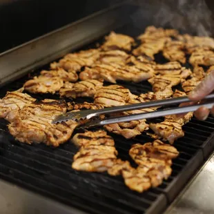 a person cooking on a grill