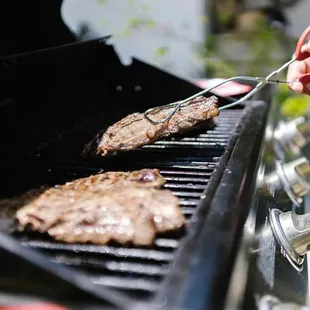 a person using a pair of tongs