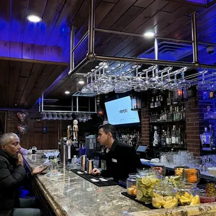 two men sitting at a bar