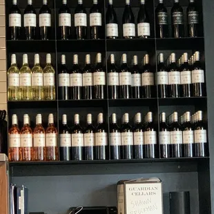 a shelf full of wine bottles