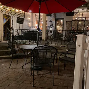 a patio with tables and chairs