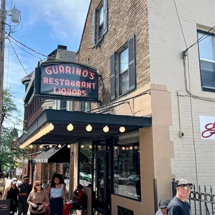 people walking in front of the restaurant