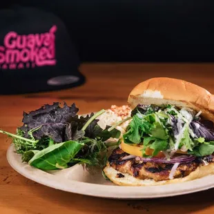 Guava Smoked Pork Burger on a Toasted Onion Bun, Red Onions, Tomato, and Kahumana Mixed Greens w/ our Creamy Vinaigrette Dressing...Must Try