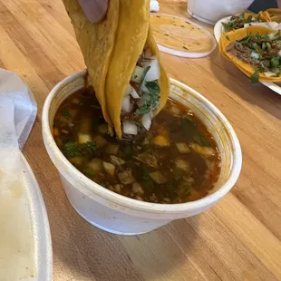 Birria tacos dipped in consommé.