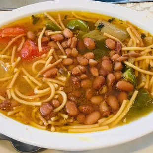 a bowl of soup with noodles and beans