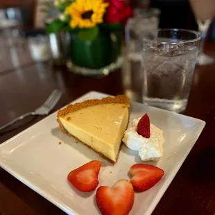 a slice of cheesecake and strawberries
