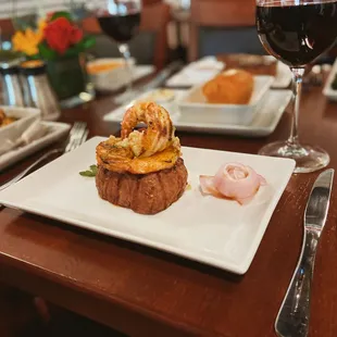 a plate of food and a glass of wine