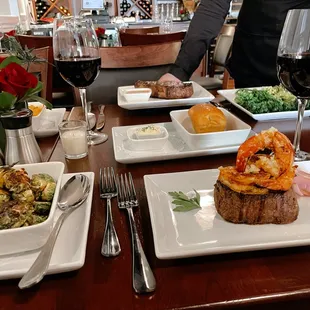 a table of food and wine glasses