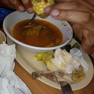 a person eating a bowl of soup