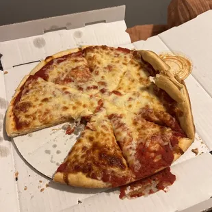 a half eaten pizza in a box