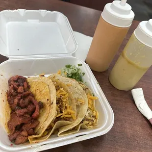 a plate of tacos and a drink