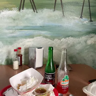 a tray of food and a bottle of soda