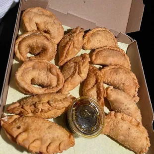 Assorted shapes of empanada - a little descriptive map or menu could have helped identify which was which and delicious chimichurri sauce