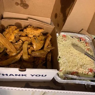 a box of chicken wings and fries