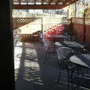 a patio with tables and chairs