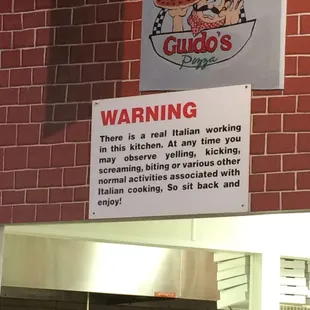 a sign on a brick wall