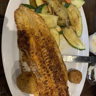 Blackened Catfish with seasoned veggies and hush puppies