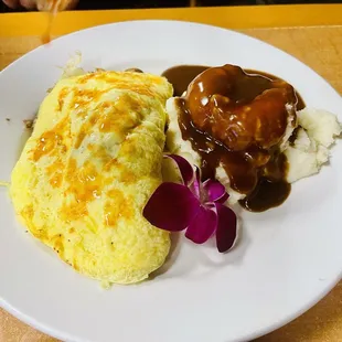Philly cheesesteak with scrambled eggs and mashed potatoes and gravy