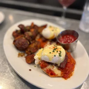 BENEDICT Maple braised pork belly, melted cherry tomatoes, home fries, hollandaise