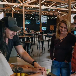 a group of people standing around a table