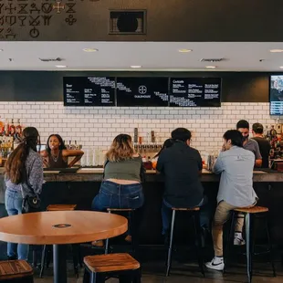 a group of people sitting at a bar