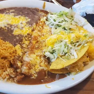 Enchiladas combo with chicken soggy taco and burnt beans and cold rice