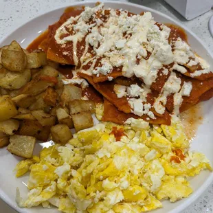 Red sauce Chilaquiles, eggs and country potatoes.