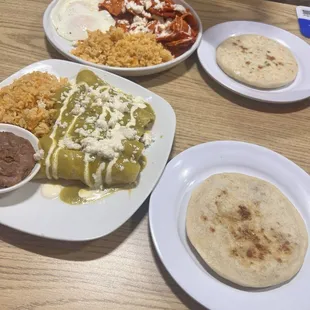 Green enchiladas and red chilaquiles with an over easy egg  cheese spinach, cheese chicharon pupusas