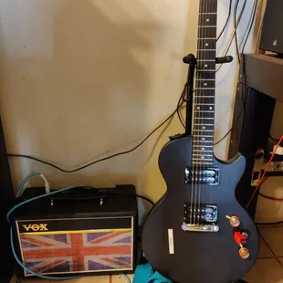 Epiphone Les Paul Special $89 and Vox amp $79. They sound great.