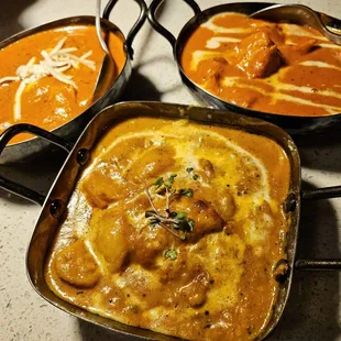 On the upper left is paneer tikka masala, on the top right is chicken paneer, and in the bottom middle is the fish pineapple curry.