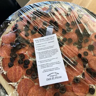 a pizza wrapped in plastic
