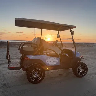 Golf cart and sunrise at jetty